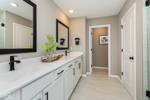 bathroom with vanity and a shower with shower door