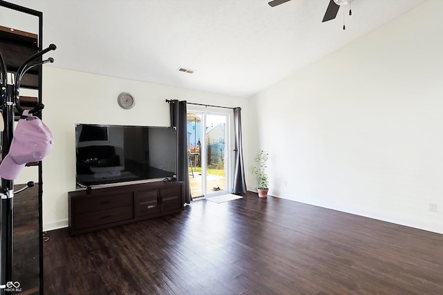 living room featuring vaulted ceiling, ceiling fan, and dark hardwood / wood-style floors