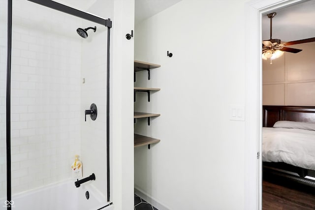 bathroom with hardwood / wood-style floors, tiled shower / bath combo, and ceiling fan