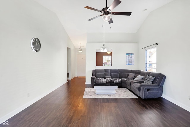 living room with ceiling fan, dark hardwood / wood-style flooring, and high vaulted ceiling