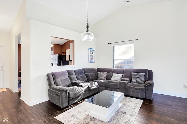 living room featuring dark hardwood / wood-style floors and lofted ceiling