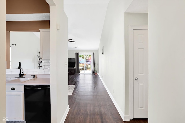 hallway featuring dark hardwood / wood-style flooring, vaulted ceiling, and sink