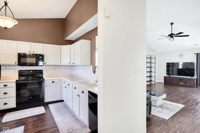 kitchen with white cabinetry, pendant lighting, black appliances, and dark hardwood / wood-style floors