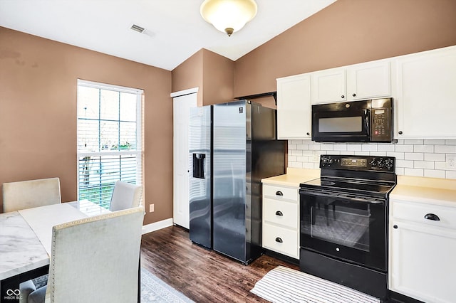 kitchen with lofted ceiling, black appliances, a kitchen breakfast bar, white cabinets, and dark hardwood / wood-style flooring