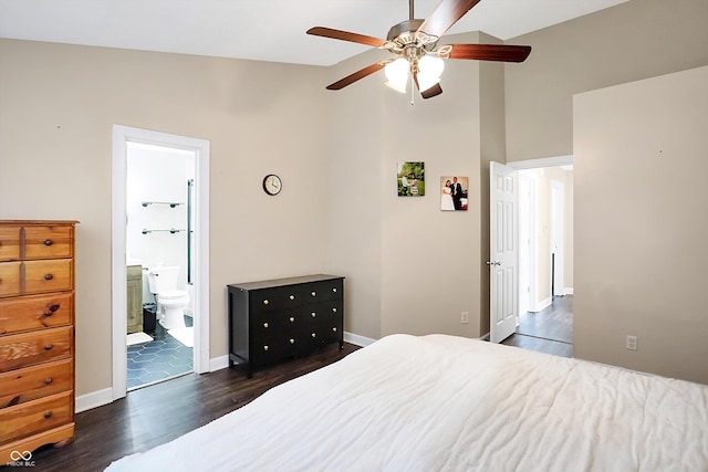 bedroom featuring vaulted ceiling, ensuite bath, ceiling fan, and dark wood-type flooring