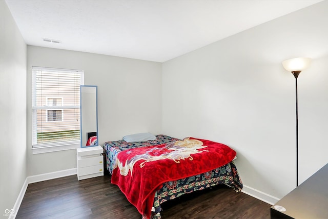 bedroom with dark wood-type flooring