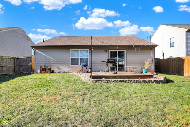 rear view of house with a yard