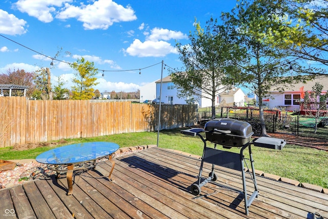 deck featuring area for grilling and a yard