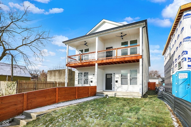 back of property featuring a lawn and a balcony