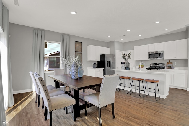 dining room featuring light hardwood / wood-style flooring and sink