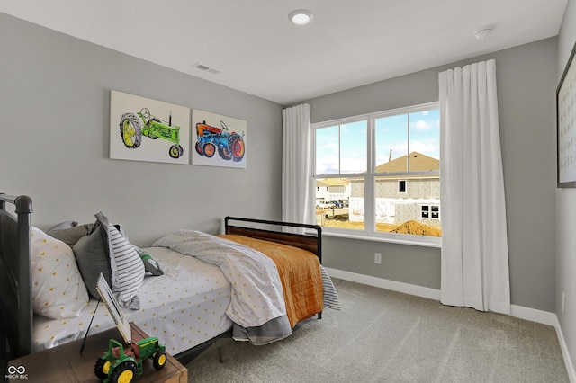 bedroom featuring light colored carpet