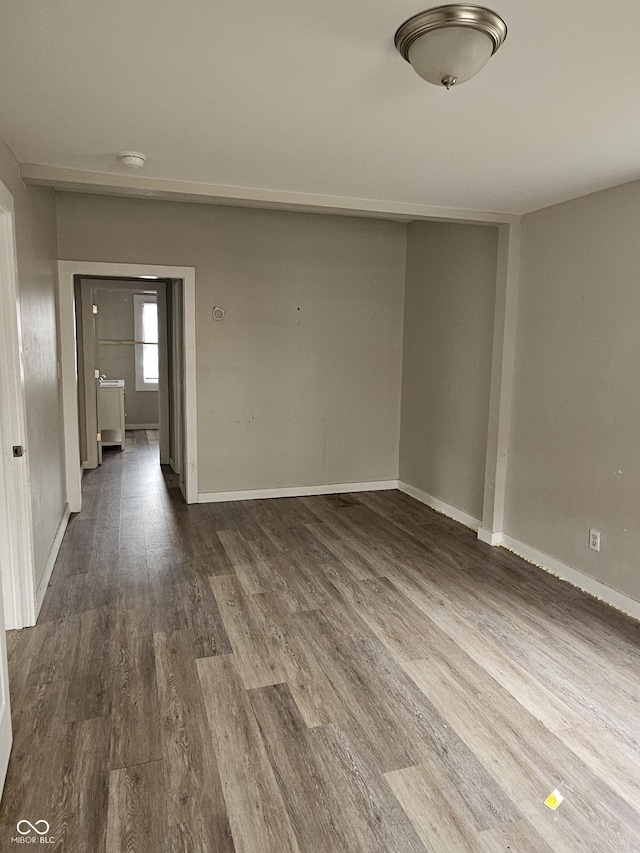 unfurnished room featuring dark hardwood / wood-style floors