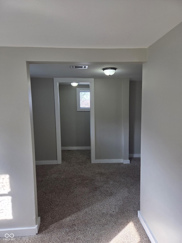 interior space with carpet, visible vents, and baseboards