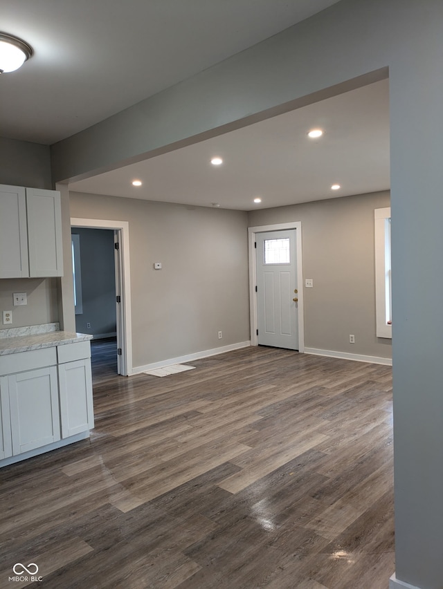 interior space with dark wood-style floors, recessed lighting, and baseboards