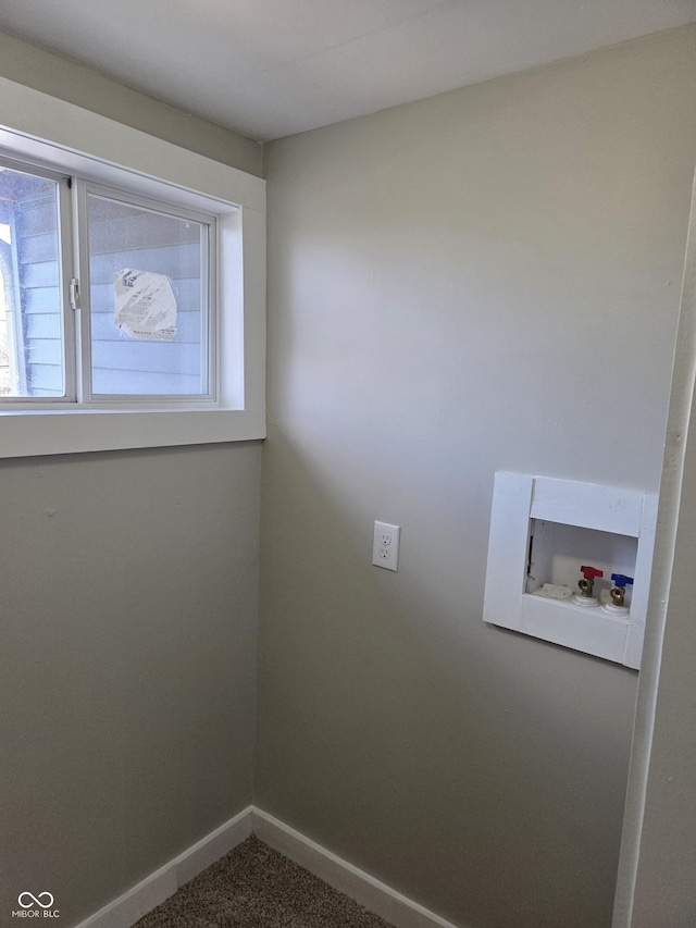 clothes washing area with laundry area, dark colored carpet, hookup for a washing machine, and baseboards