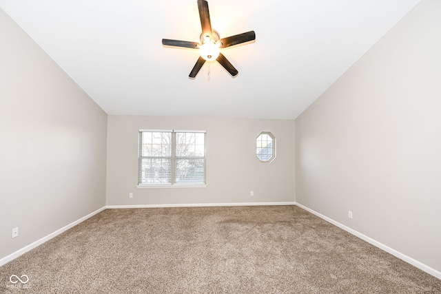 spare room featuring carpet flooring, vaulted ceiling, and ceiling fan