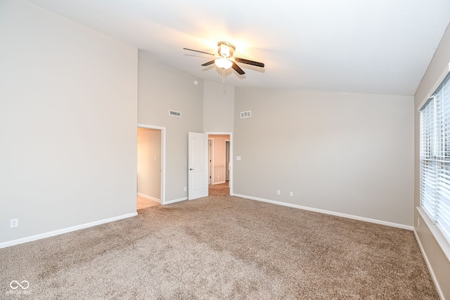 spare room featuring carpet flooring, ceiling fan, and lofted ceiling