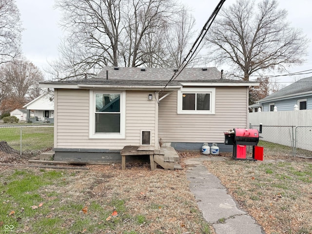 rear view of house with a lawn