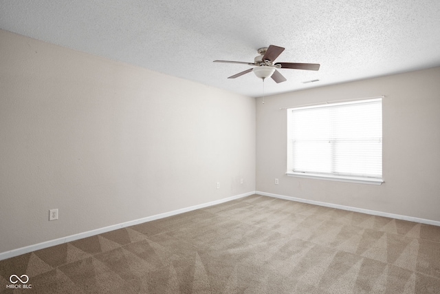 empty room with carpet flooring, a textured ceiling, and ceiling fan