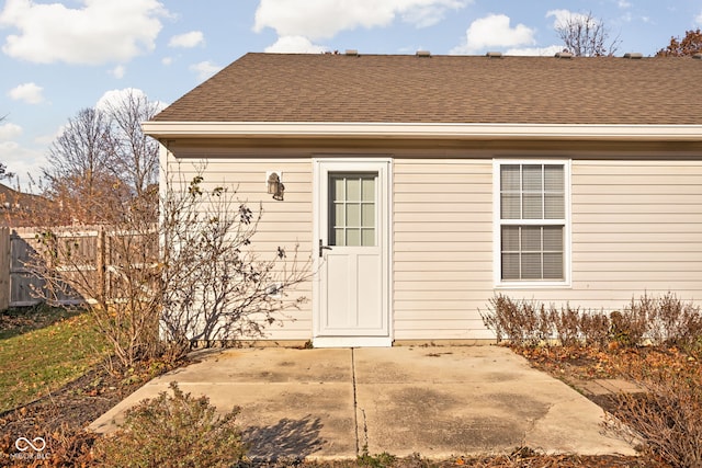 view of exterior entry with a patio area