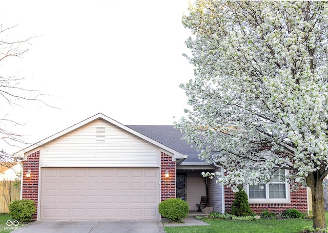 single story home featuring a garage and a front lawn