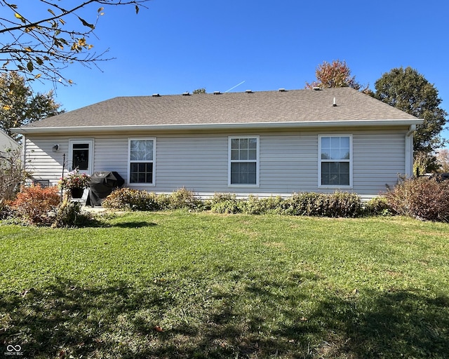 rear view of house with a lawn