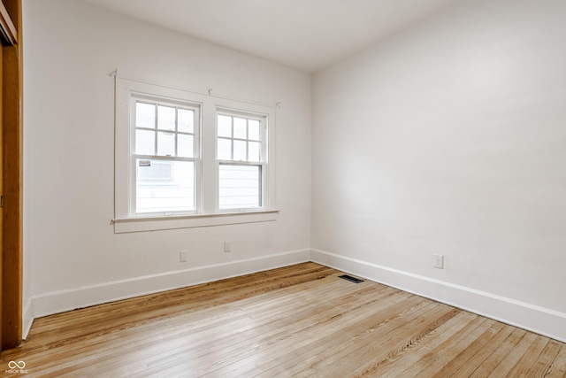 spare room featuring light hardwood / wood-style floors