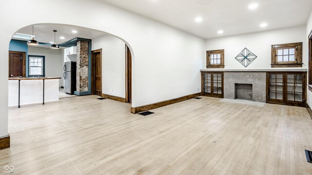 unfurnished living room featuring a fireplace and light wood-type flooring