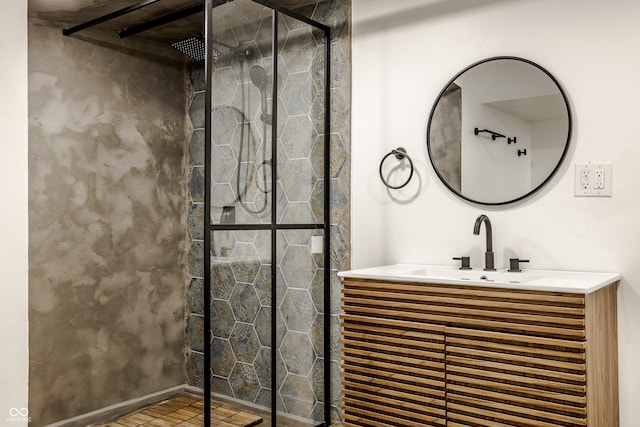 bathroom featuring tile patterned floors, vanity, and tiled shower