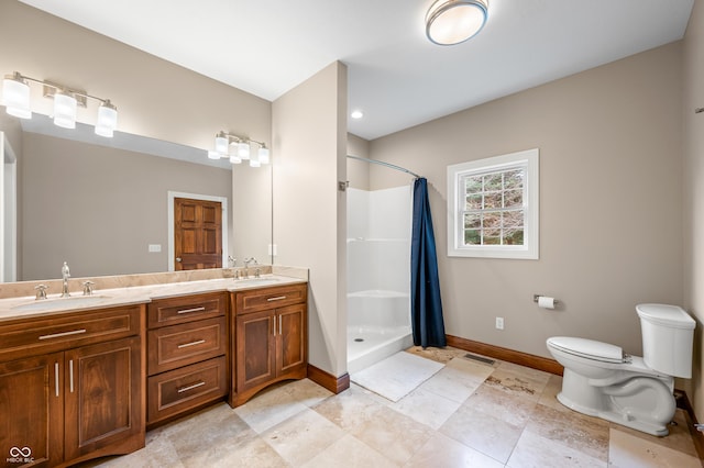 bathroom featuring vanity, curtained shower, and toilet