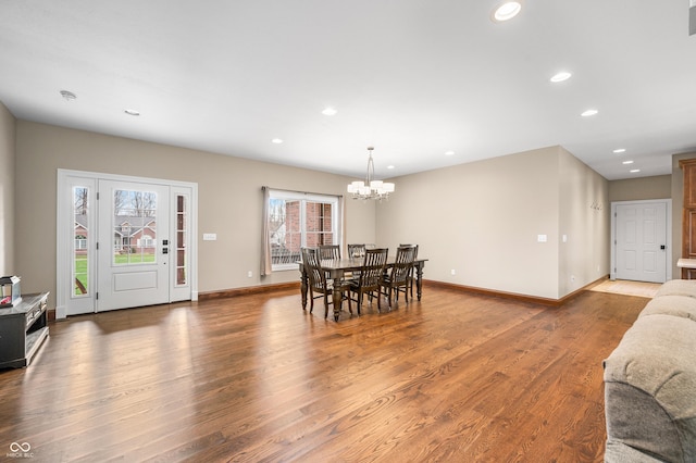 dining room featuring hardwood / wood-style floors and an inviting chandelier