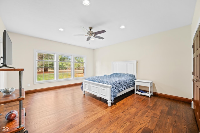 bedroom with ceiling fan and wood-type flooring