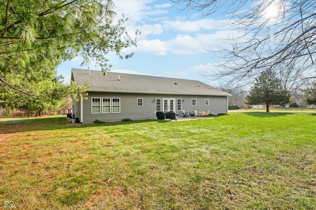 back of property featuring a patio area and a lawn