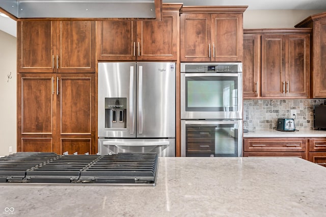 kitchen with stainless steel appliances and tasteful backsplash