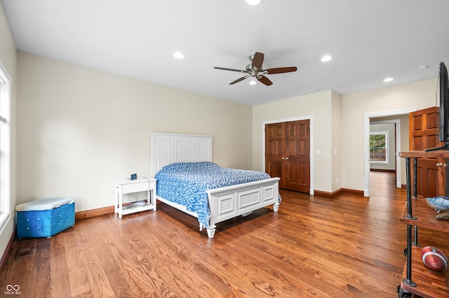 bedroom with hardwood / wood-style floors and ceiling fan