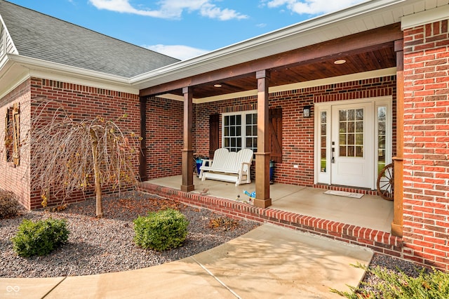 view of exterior entry with covered porch