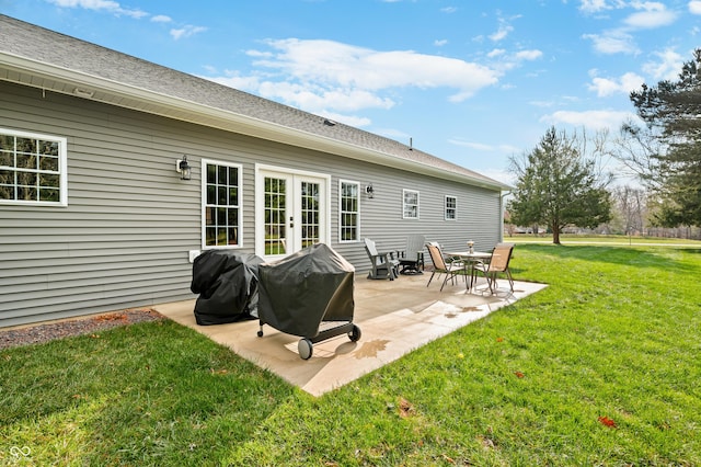 rear view of property with a yard and a patio