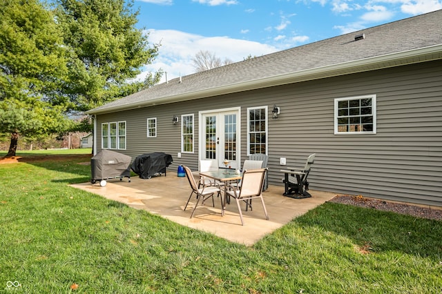 rear view of property with a lawn and a patio area