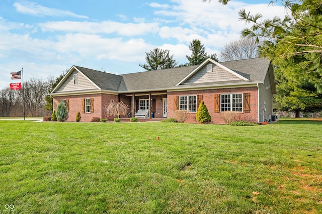 ranch-style home featuring a front yard and central air condition unit