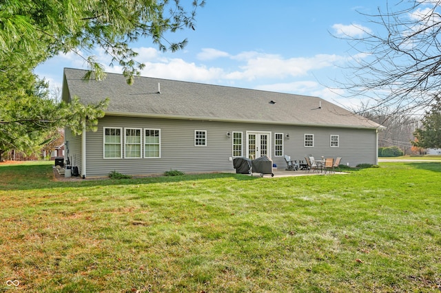 rear view of property featuring a lawn and a patio area