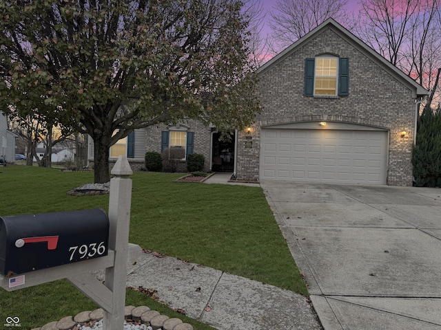 view of front of house featuring a yard and a garage