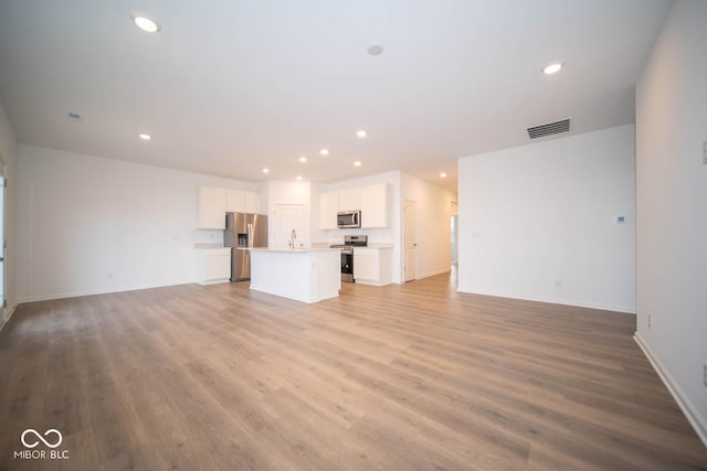 5607 Tart Blvd, Indianapolis, IN 46239 - unfurnished living room featuring recessed lighting and wood finished floors