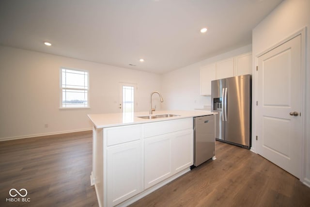 5607 Tart Blvd, Indianapolis, IN 46239 - kitchen with appliances with stainless steel finishes, dark wood-type flooring, white cabinets, an island with sink, and light countertops