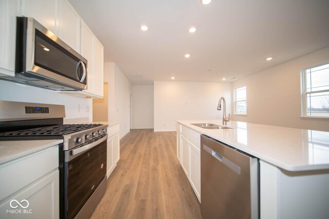5607 Tart Blvd, Indianapolis, IN 46239 - kitchen with stainless steel appliances, white cabinetry, light wood finished floors, recessed lighting, and healthy amount of natural light