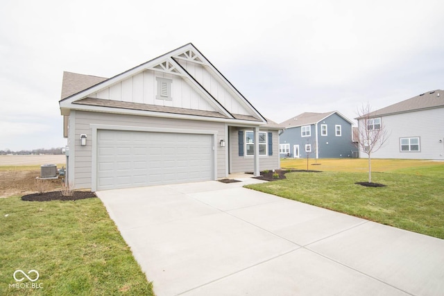 view of front facade with central AC unit, a garage, and a front lawn