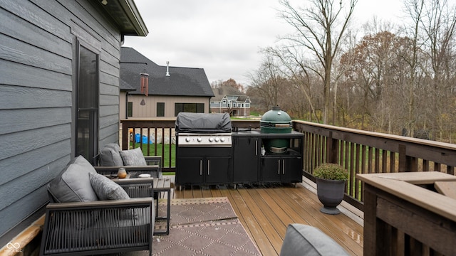 wooden deck featuring a grill and exterior kitchen