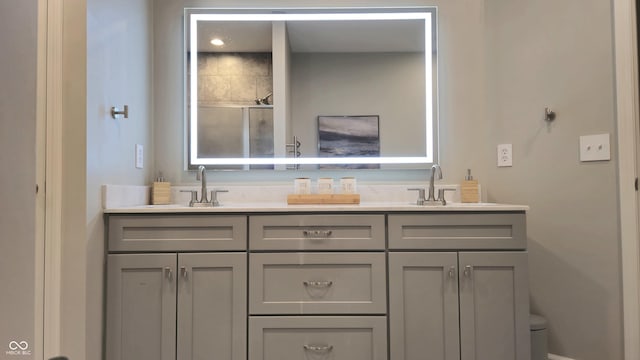 bathroom featuring vanity and a shower with shower door