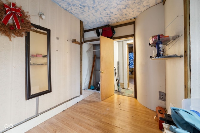 interior space with wood walls and hardwood / wood-style floors