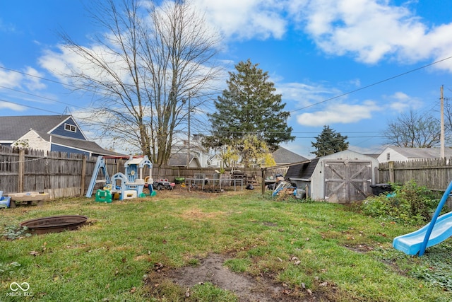 view of yard featuring a storage shed and a playground