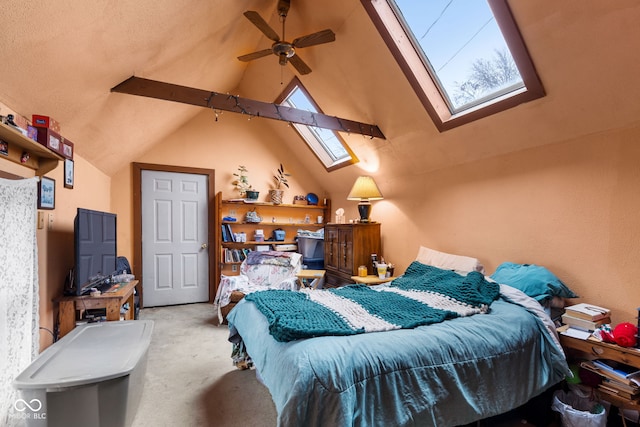 carpeted bedroom featuring beamed ceiling, ceiling fan, high vaulted ceiling, and a skylight